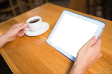 Person holding cup and digital tablet