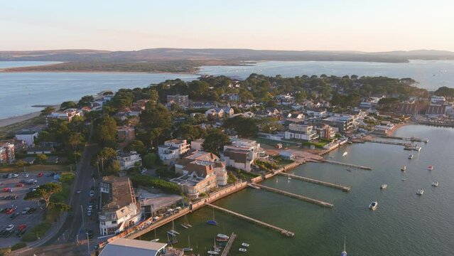 Poole, UK: Aerial view of city in England, seaside resort with famous Beaches by Atlantic Ocean, Sandbanks neighbourhood in summer at sunset - landscape panorama of United Kingdom from above