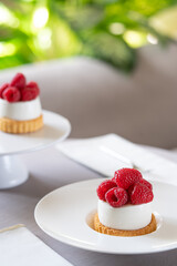 Cheesecake  with raspberries on white plate.  Selective focus