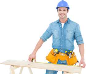Happy male carpenter measuring wooden plank