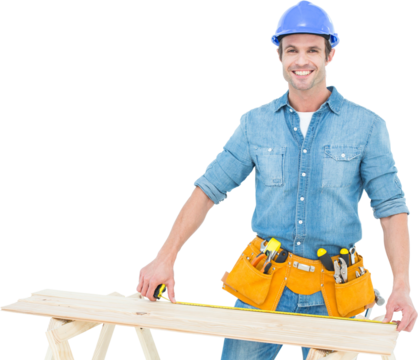 Happy male carpenter measuring wooden plank