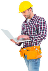 Confident handyman using laptop