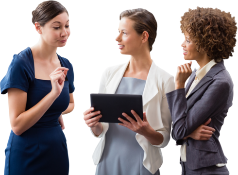 Businesswomen discussing over tablet while standing against white backgorund