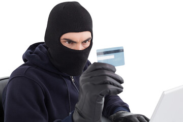 Burglar using credit card and laptop