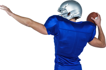 Rear view of American football player throwing ball