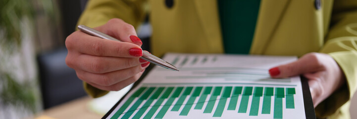 Businesswoman holds financial report and analytics in charts