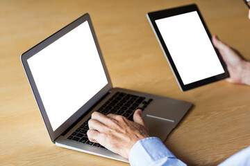 Cropped image of hand holding digital tablet