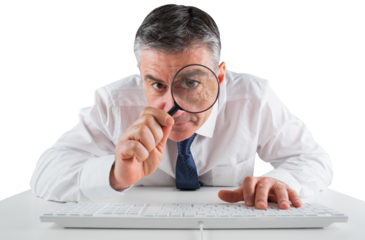 Mature businessman examining with magnifying glass