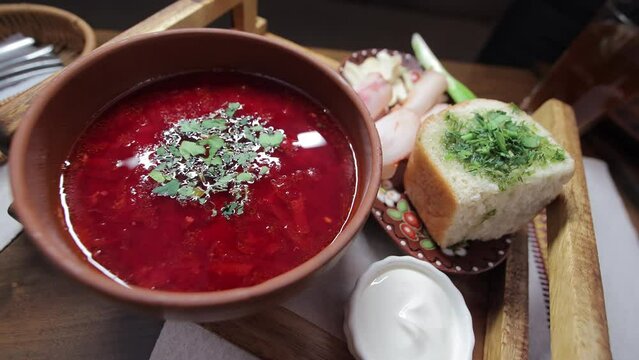 Ukrainian borscht with donuts and greens. National dish in Ukraine.
