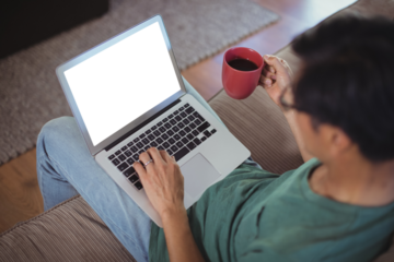 Man using laptop in living room