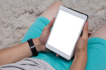 Man using digital tablet on the beach