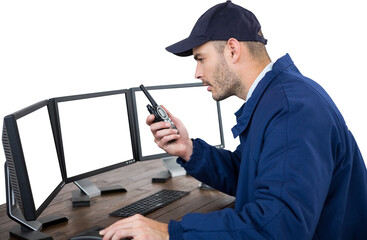 Security officer talking on walkie talkie while observing computer monitor