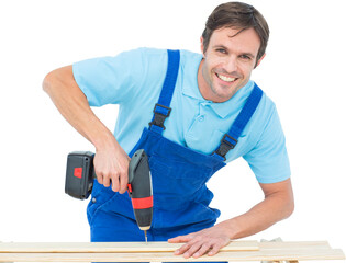 Carpenter using drill machine on wood