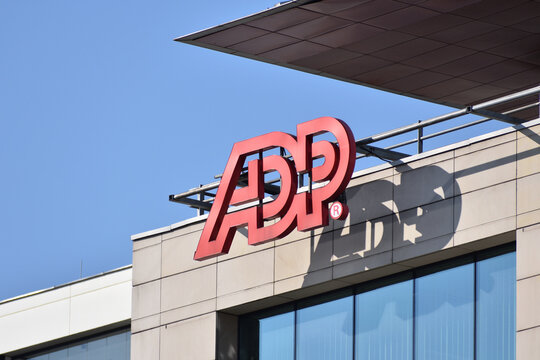 ADP (Automatic Data Processing) signage, logo, emblem on the facade of an American provider of human resources management software and services. WARSAW, POLAND - MARCH 13, 2022