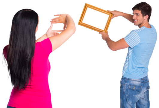 Young couple hanging a frame