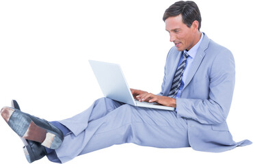 Businessman using laptop while sitting over white background