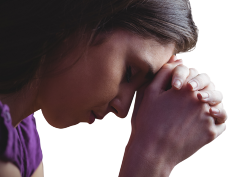 Close up of woman praying with hands together