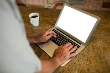 Cropped image of senior man using laptop