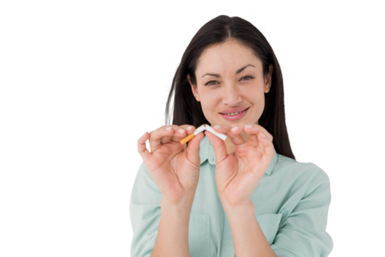 Smiling woman snapping cigarette in half