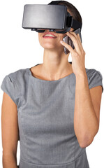Happy woman talking on mobile phone while using virtual reality headset