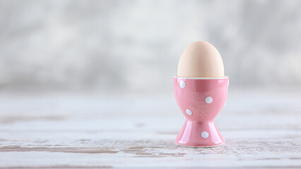 pink egg on wooden table