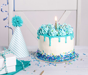 Blue and white Birthday party with cake, gifts and hat over white background. - 588462003