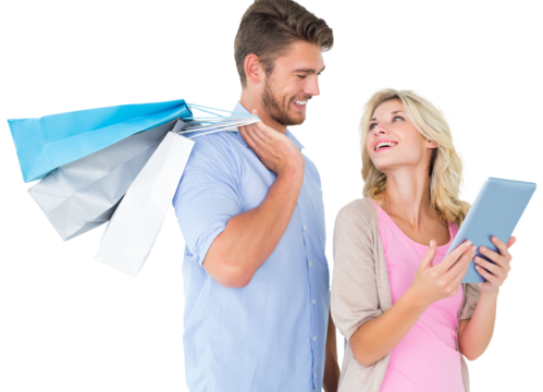 Attractive young couple holding shopping bags looking at tablet pc