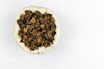 Raw Carob Kibble Nibbles, Top View Isolated on a White Background, for Snacks and Healthy Eating