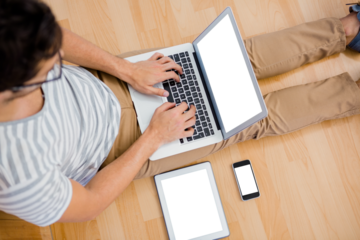 Overhead view of a man using laptop in living room