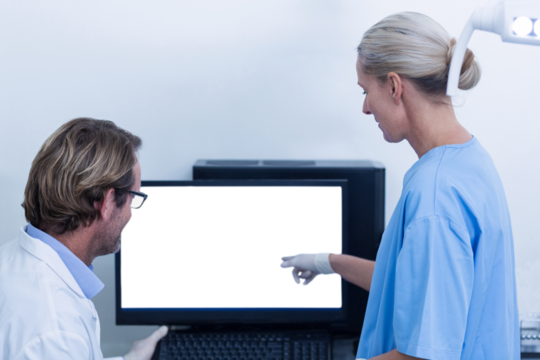 Dentist and dental assistant discussing a x-ray on the monitor