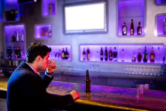 Businessman holding drinking glass - Powered by Adobe