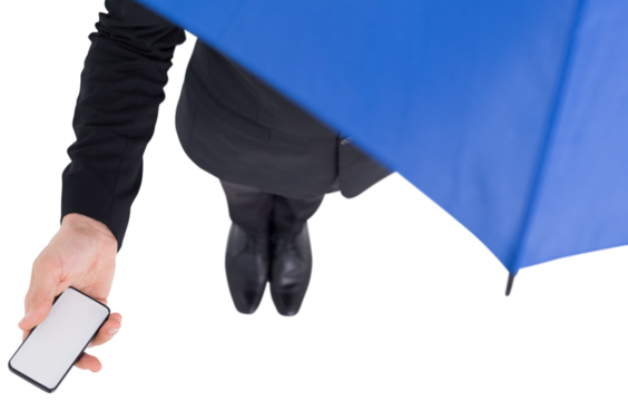 Businessman under umbrella holding mobile phone