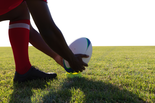 Man putting in grass rugby ball