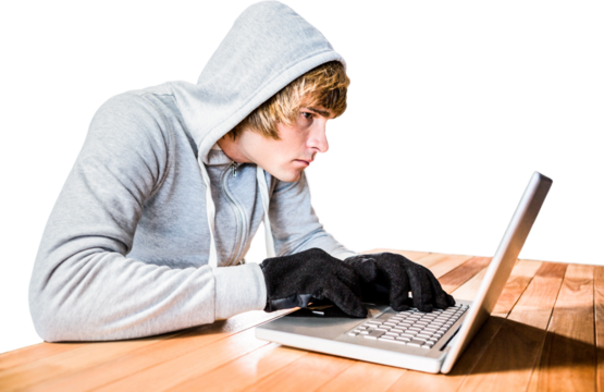 Focused man with hoodie typing on laptop