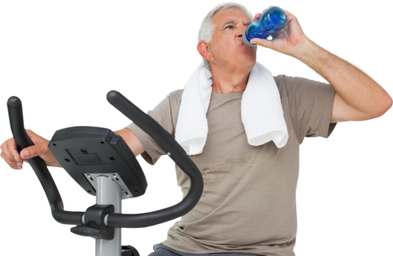 Senior man drinking water on stationary bike