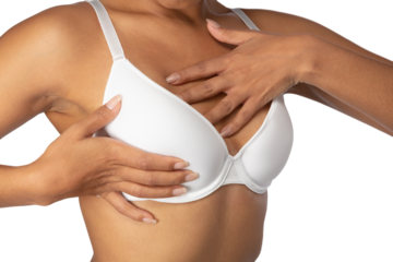 Woman standing for breast cancer awareness in white bra against white background
