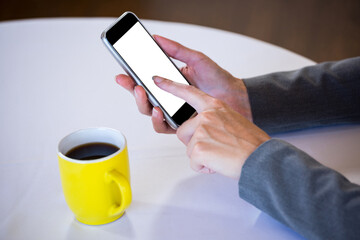 Woman using mobile phone at table