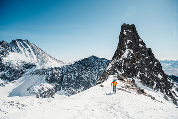 Mountaineer backcountry ski walking ski alpinist in the mountains. Ski touring in alpine landscape...