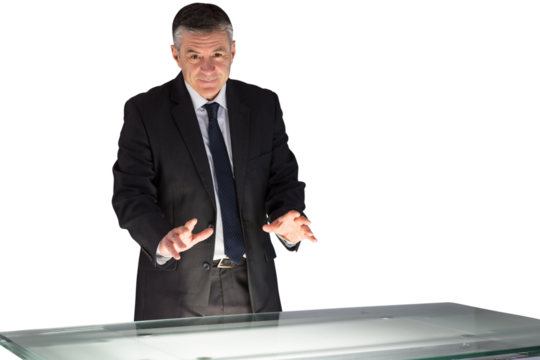 Mature businessman using interactive desk - Powered by Adobe
