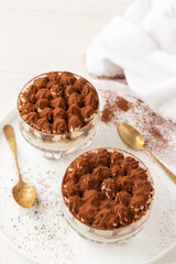 Classic eggless Tiramisu, the famous Italian dessert on a white background.