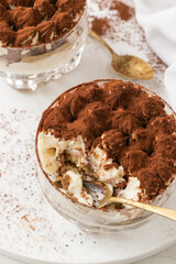 Classic eggless Tiramisu, the famous Italian dessert on a white background.
