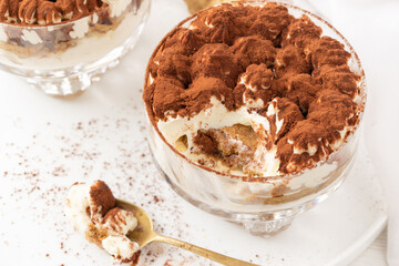 Classic eggless Tiramisu, the famous Italian dessert on a white background.