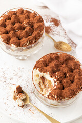 Homemade traditional Italian dessert, classic Tiramisu without eggs and heavy cream, on white background.