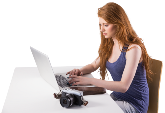 Pretty redhead working on laptop
