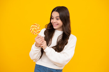 Teenage girl with lollipop, child eating sugar lollipops, kids sweets candy shop. Excited teenager girl. Happy face, positive and smiling emotions of teenager girl.