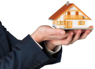 Businessman holding miniature house model