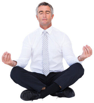 Zen businessman meditating in lotus pose 
