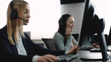 Team of call center employees work in office, answer customer calls and communicate with corporate customers. diverse group of people is negotiating hotline sale. Busy salesman in the agency office - Powered by Adobe