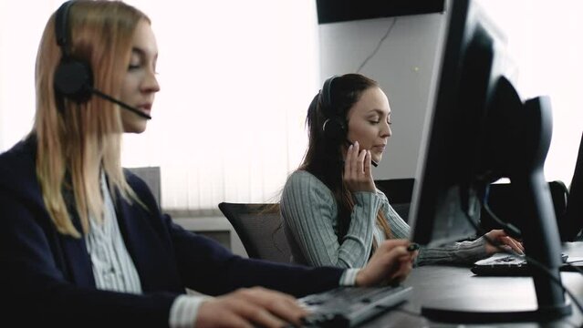 Team of call center employees work in office, answer customer calls and communicate with corporate customers. diverse group of people is negotiating hotline sale. Busy salesman in the agency office