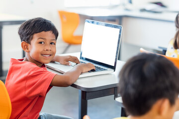 Smiling boy using laptop